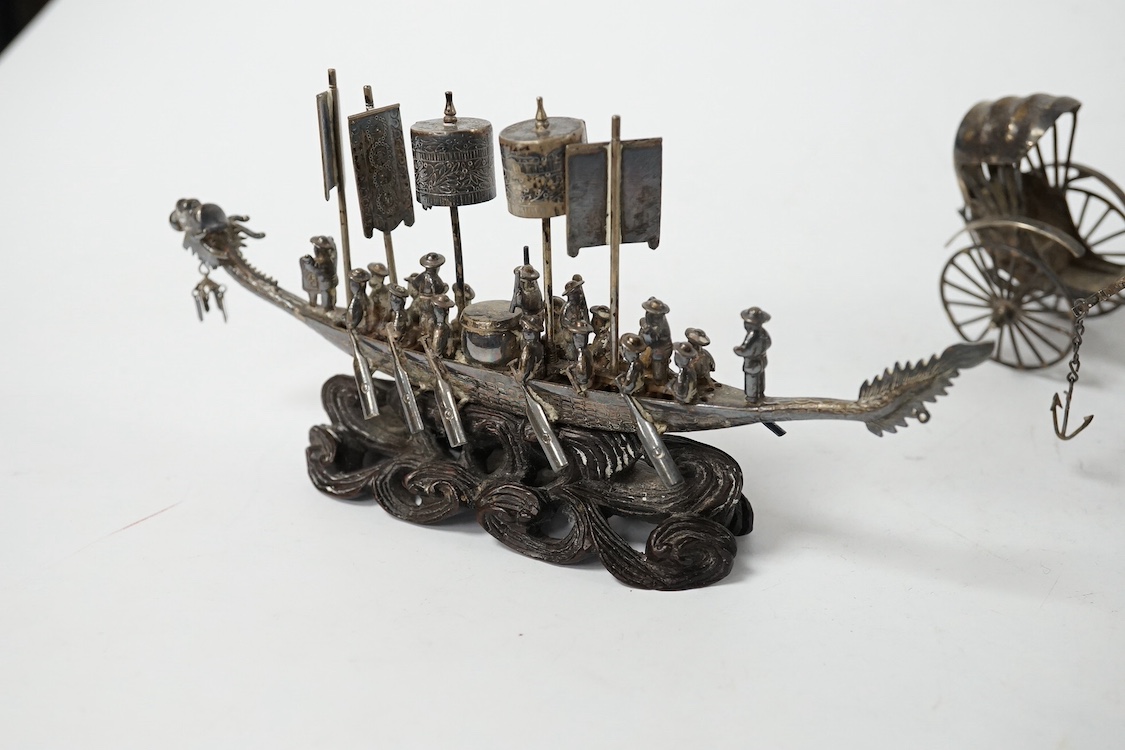 A Chinese white metal miniature model of a junk, length 11.2cm, on a wooden stand, a similar late 19th/early 20th century miniature filigree sedan chair and rickshaw by Kwan Wo and a Chinese white metal model of a boat w